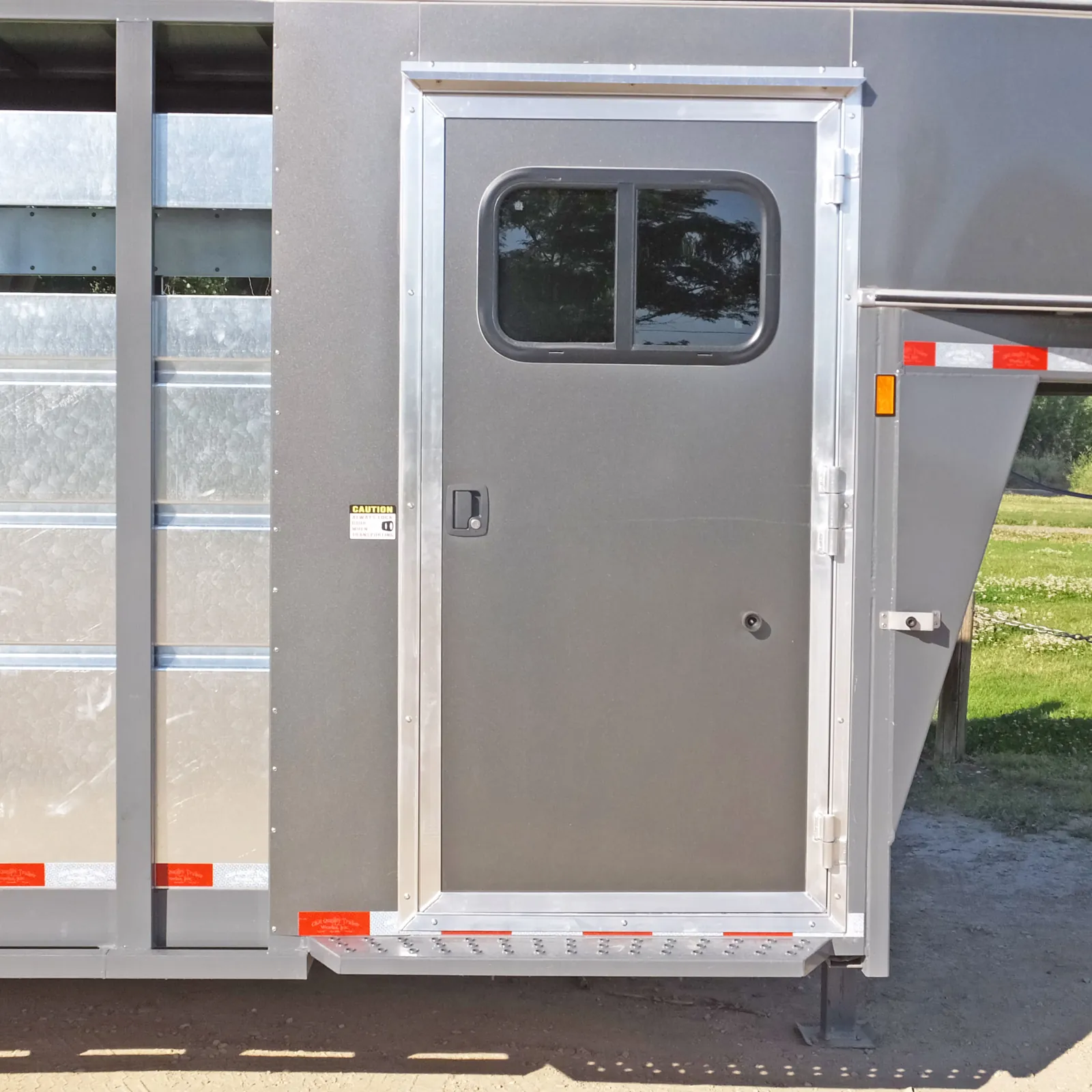 Camper style tack door with slider window.
